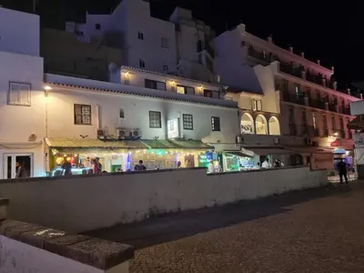 a group of buildings and a street at night at Wonder Charm Guesthouse in Albufeira