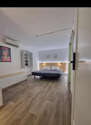 a bedroom with a bed in the middle of a room at Wonder Charm Guesthouse in Albufeira