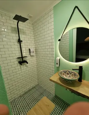 a bathroom with a mirror and a bowl on a counter at Wonder Charm Guesthouse in Albufeira