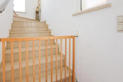 a stairway with a wooden railing next to a stair case at Villa Tio Pedro - Swimming Pool - For families- BY BEDZY in Albufeira
