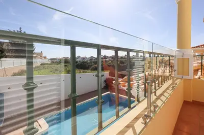 a balcony with a view of a swimming pool at Villa Tio Pedro - Swimming Pool - For families- BY BEDZY in Albufeira