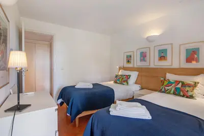 a hotel room with two beds and a lamp at Casa do Pateo in Guia