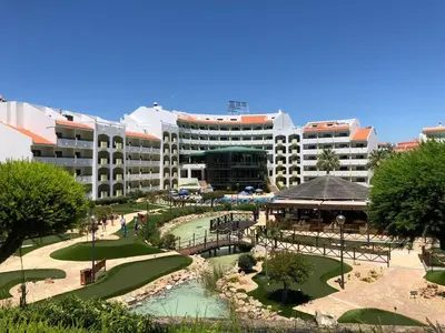 a large building with a river in front of it at Amazing ApartHotel Apartments 2 Bedroom in Albufeira in Albufeira