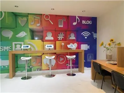 a room with a colorful wall with a table and stools at Amazing ApartHotel Apartments 2 Bedroom in Albufeira in Albufeira