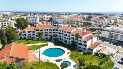a bedroom with a bed with two towels on it at Saro Apartment by HelloVacations in Albufeira