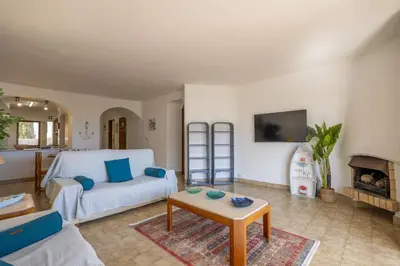 a living room with a couch and a table at Apartamento de 2 quartos Hibiscus 40A na Praia de Sao Rafael - Albufeira, Algarve in Albufeira