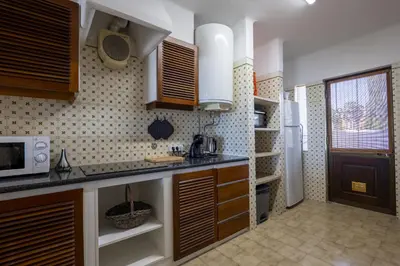 a kitchen with a sink and a refrigerator at Apartamento de 2 quartos Hibiscus 40A na Praia de Sao Rafael - Albufeira, Algarve in Albufeira