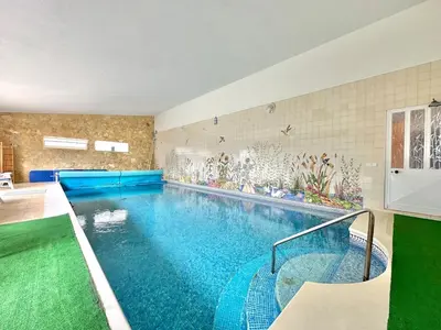 a large swimming pool in a room with at Casa Alfarroba - with heated indoor pool in Algoz