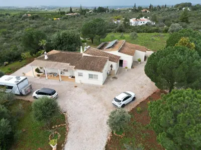 an aerial view of a house with two cars parked at Casa Alfarroba - with heated indoor pool in Algoz