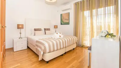 a white bedroom with a bed and a window at Vilamoura - VILLA LIMONI in Vilamoura