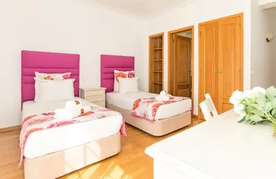 two beds in a room with purple and white at Vilamoura - VILLA LIMONI in Vilamoura
