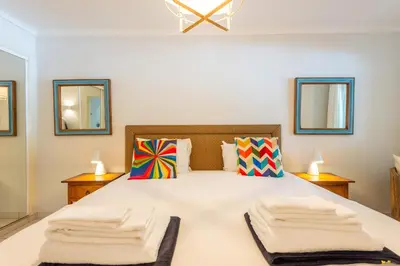 a bedroom with a large bed with two towels on it at Jardins do Golfe at Vale do Lobo in Vale do Lobo
