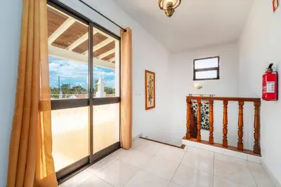 a room with a large window and a staircase at Villa 4 Quartos, Piscina, AC, Jardim, Prestige For Home in Loulé