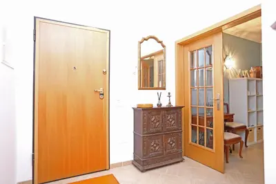 a room with a wooden door and a dresser at A32 - Lancemar Flat in Albufeira in Albufeira