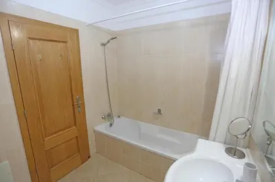 a bathroom with a tub and a toilet and a sink at A32 - Lancemar Flat in Albufeira in Albufeira