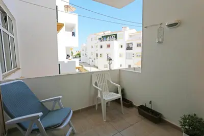 two chairs sitting on the balcony of a building at A32 - Lancemar Flat in Albufeira in Albufeira