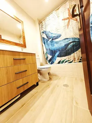 a bathroom with a toilet and a painting on the wall at Blife Paulya private apartment in Faro