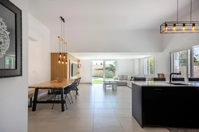a kitchen and living room with a table and a dining room at Beautiful Villa with a Pool in Albufeira