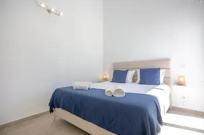 a bedroom with a large bed with two towels on it at Beautiful Villa with a Pool in Albufeira