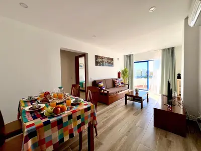 a living room with a table with fruit on it at Vilamoura Design 2 by Homing in Vilamoura