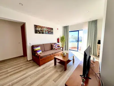 a living room with a couch and a tv at Vilamoura Design 2 by Homing in Vilamoura