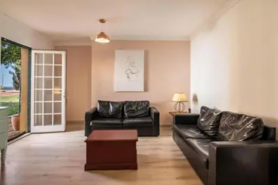 a living room with a couch and a table at Casa da Vigia - waking up in front of the sea in Albufeira