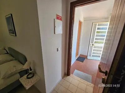a bedroom with a bed and a door to a hallway at Blife Benya private apartment in Faro