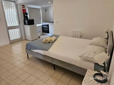 a bedroom with a large bed with two pillows on it at Blife Benya private apartment in Faro