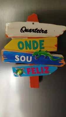 a stack of books hanging on a wall at Fernandes Holidays in Quarteira