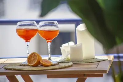 two glasses of wine and oranges on a table at Mary's Ocean in Albufeira