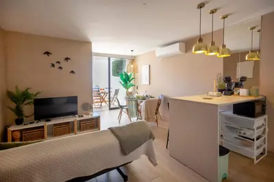 a living room with a kitchen and a living room with a table at Mary's Ocean in Albufeira