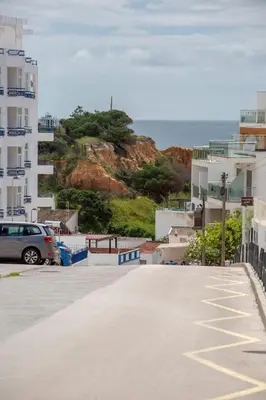 a car parked in a parking lot next to buildings at Mary's Ocean in Albufeira