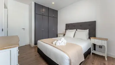 a bedroom with a bed with two stuffed animals on it at Cozy 2BR near Oura Beach by LovelyStay in Albufeira