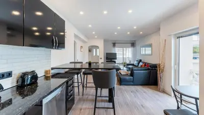 a kitchen and living room with a table and chairs at Cozy 2BR near Oura Beach by LovelyStay in Albufeira