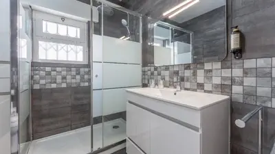 a bathroom with a sink and a shower at Cozy 2BR near Oura Beach by LovelyStay in Albufeira