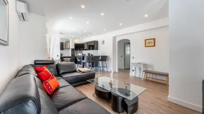 a living room with a leather couch and a table at Cozy 2BR near Oura Beach by LovelyStay in Albufeira