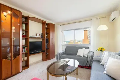a living room with a couch and a table at TAC - Bright Coast Quarteira in Quarteira