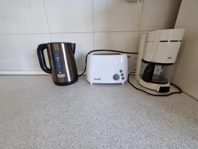 a coffee maker and a toaster sitting on a counter at TAC - Bright Coast Quarteira in Quarteira