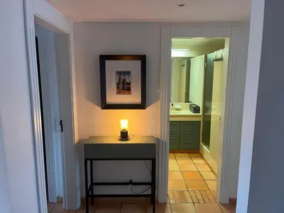 a bathroom with a table with a candle on it at SomeSunnyDay Vila Sol Village in Quarteira