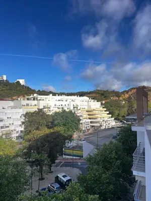 a view of a city with white buildings and trees at Ilumina Hostel Albufeira in Albufeira