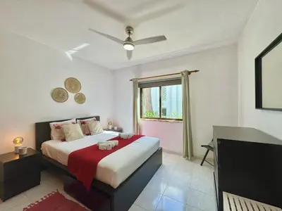 a bedroom with a large bed and a window at Vilamoura Golf Apartment 2 With Pool by Homing in Vilamoura
