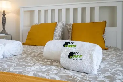 a bed with two pillows on top of it at BmyGuest - Quinta do Lago Cosy Apartment in Quinta do Lago