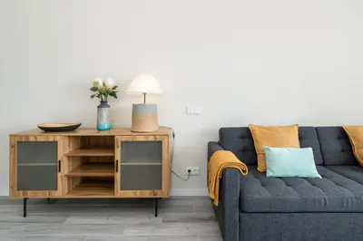 a living room with a blue couch and a table at BmyGuest - Quinta do Lago Cosy Apartment in Quinta do Lago
