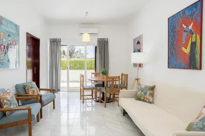 a living room with a couch and chairs and a table at Aldeia do Mar Vilamoura, Pool Terrace, by Hopstays in Quarteira