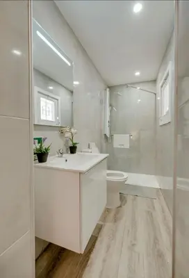 a white bathroom with a sink and a toilet at Apartamento Condomínio Montechoro by CM Properties in Albufeira