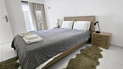 a bedroom with a large bed and a night stand at Albufeira, Blue Wave Retreat 64 in Albufeira
