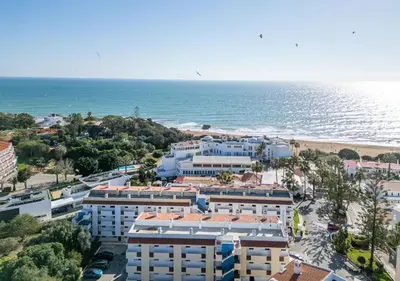 an aerial view of the beach and buildings at Passport Beach - 201 by HelloVacations in Albufeira