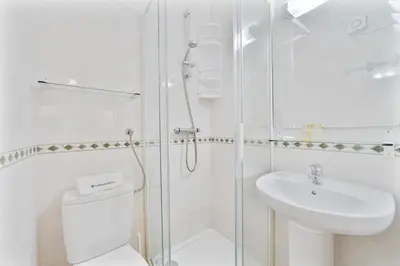 a bathroom with a shower and a toilet and a sink at Passport Beach - 201 by HelloVacations in Albufeira
