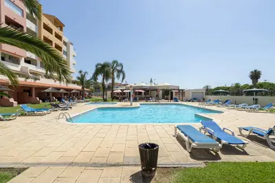 a swimming pool with lounge chairs and a resort at Dream place- Bela Vista in Albufeira