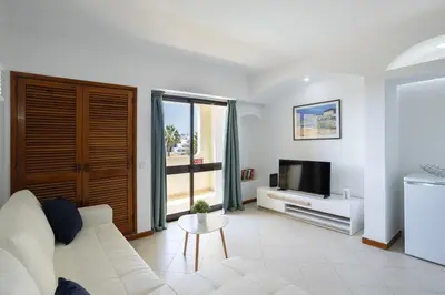 a living room with a white couch and a tv at Dream place- Bela Vista in Albufeira